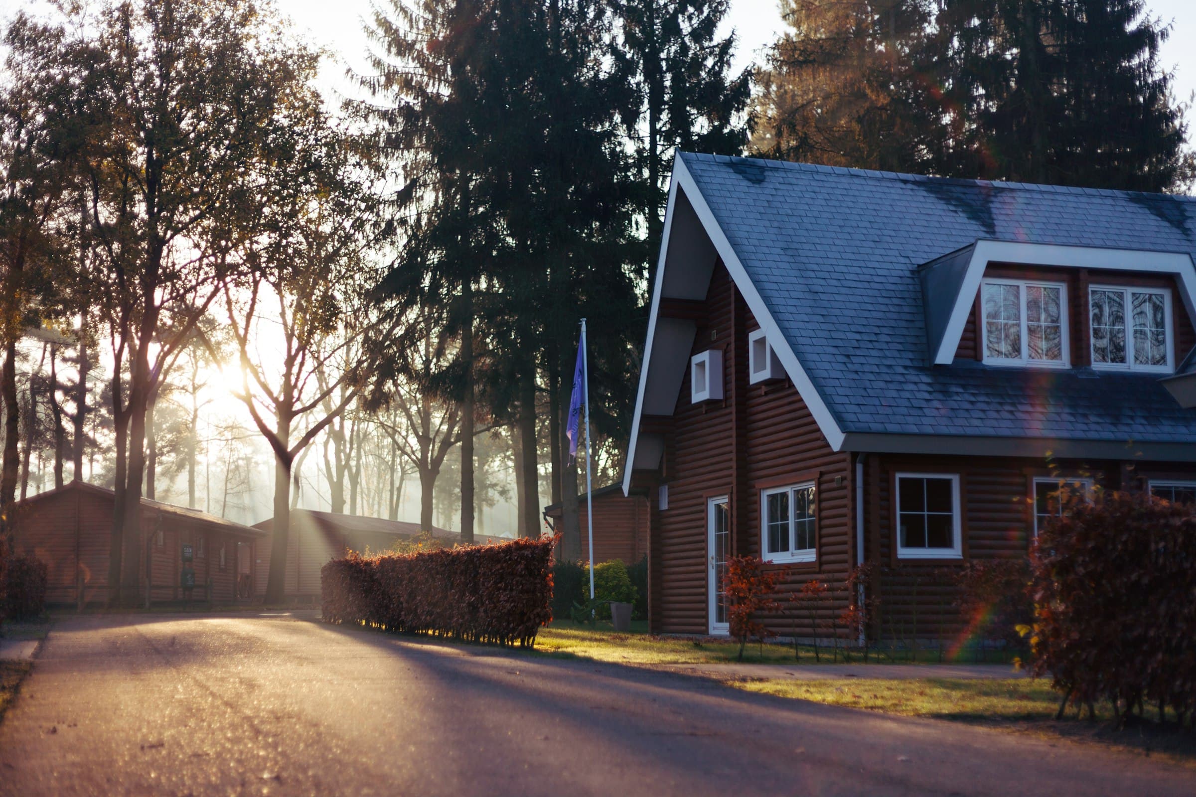 House and porch at dusk with a light in the window