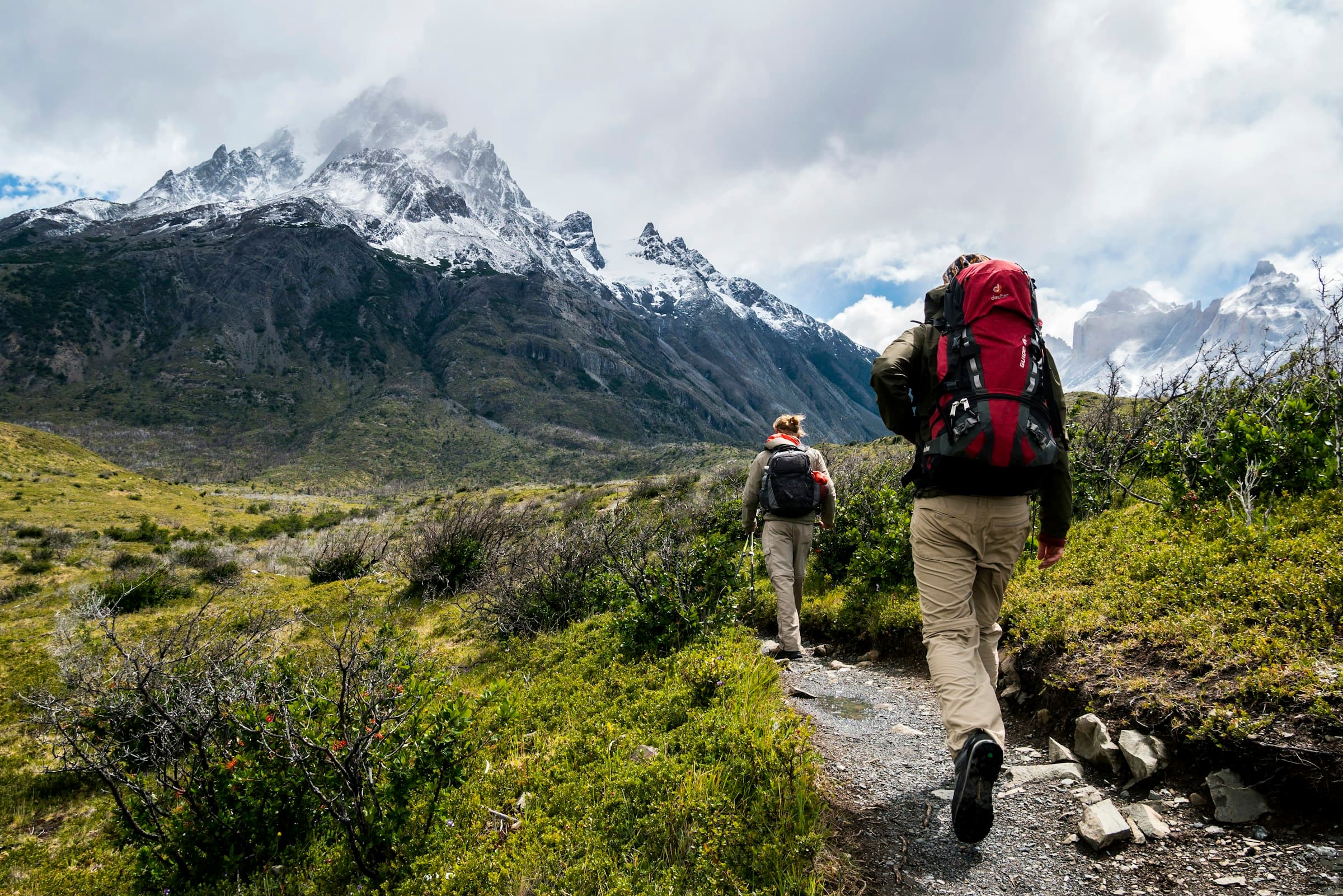 Hikers on a switchback with packs, open country ahead
